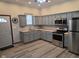 Well-equipped kitchen featuring stainless appliances and gray cabinetry at 624 Warren Ave, Indianapolis, IN 46221