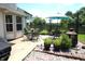 Paver patio area with a view of the backyard equipped with tables, chairs, and an umbrella at 6422 Hollingsworth Dr, Indianapolis, IN 46268