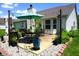A paver patio with a view of the backyard featuring a table, chairs, umbrella, and landscaping at 6422 Hollingsworth Dr, Indianapolis, IN 46268