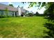 Spacious backyard with a well-kept lawn, patio, and privacy fence, perfect for outdoor gatherings at 6422 Hollingsworth Dr, Indianapolis, IN 46268
