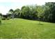 A spacious backyard features a paver patio with furniture and an umbrella, offering a relaxing outdoor retreat at 6422 Hollingsworth Dr, Indianapolis, IN 46268