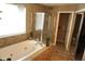 Elegant bathroom boasting a large bathtub, a shower with glass doors, and decorative lighting at 6422 Hollingsworth Dr, Indianapolis, IN 46268
