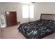A cozy bedroom with dinosaur themed bedding is equipped with a ceiling fan, dresser, and framed mirror at 6422 Hollingsworth Dr, Indianapolis, IN 46268