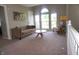 Cozy bonus room upstairs with seating, a large window, and a neutral color palette at 6422 Hollingsworth Dr, Indianapolis, IN 46268