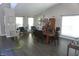 Spacious dining room featuring hardwood floors, modern lighting, neutral paint and lots of windows at 6422 Hollingsworth Dr, Indianapolis, IN 46268