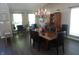 Spacious dining room featuring hardwood floors, modern lighting, neutral paint and lots of windows at 6422 Hollingsworth Dr, Indianapolis, IN 46268