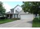 Charming two-story home featuring an attached two car garage and beautiful landscaping at 6422 Hollingsworth Dr, Indianapolis, IN 46268