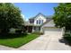 Charming two-story home with a well-manicured lawn, attached two car garage, and beautiful landscaping at 6422 Hollingsworth Dr, Indianapolis, IN 46268