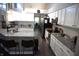 Modern kitchen featuring granite countertops, stainless steel appliances, white cabinets, and tile backsplash at 6422 Hollingsworth Dr, Indianapolis, IN 46268
