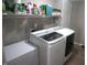 Laundry room with shelving above new washer and dryer units to maximize storage space at 6422 Hollingsworth Dr, Indianapolis, IN 46268
