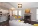 Inviting living room featuring a fireplace and an open concept kitchen with a breakfast bar at 6422 Hollingsworth Dr, Indianapolis, IN 46268