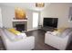 Comfortable living room featuring neutral colors, hardwood floors, and a modern fireplace at 6422 Hollingsworth Dr, Indianapolis, IN 46268