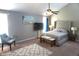 Relaxing main bedroom with a ceiling fan, a comfortable chair, and plush carpet flooring at 6422 Hollingsworth Dr, Indianapolis, IN 46268