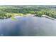 Beautiful aerial view of a serene lake with a sandy beach and lush green surroundings at 6497 Osprey Dr, Nineveh, IN 46164