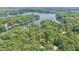 Breathtaking aerial view of a secluded lake surrounded by dense, lush forests at 6497 Osprey Dr, Nineveh, IN 46164