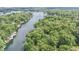 Scenic aerial view of a winding river lined with homes and lush trees, creating a peaceful and picturesque setting at 6497 Osprey Dr, Nineveh, IN 46164