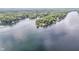 Expansive aerial view of a picturesque lake surrounded by lush green forests at 6497 Osprey Dr, Nineveh, IN 46164