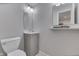 Powder room featuring a vanity sink, a decorative mirror, and a soft close toilet for convenience at 6497 Osprey Dr, Nineveh, IN 46164