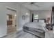 Bedroom featuring a rustic wood bed frame, neutral walls, light gray wood-look floors, and a ceiling fan at 6497 Osprey Dr, Nineveh, IN 46164