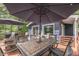 Relaxing deck showcasing outdoor dining under shade umbrellas, surrounded by trees at 6497 Osprey Dr, Nineveh, IN 46164