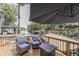 Waterside deck area featuring a fire pit table and wicker chairs, overlooking the lake at 6497 Osprey Dr, Nineveh, IN 46164