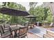 Inviting deck with dining set, grill, umbrellas, and outdoor furniture perfect for entertaining at 6497 Osprey Dr, Nineveh, IN 46164