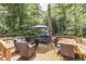 Inviting deck with wicker furniture, wooden table, and umbrella surrounded by lush trees at 6497 Osprey Dr, Nineveh, IN 46164