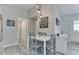Cozy dining room features a white table, grey chairs, and modern light fixture at 6497 Osprey Dr, Nineveh, IN 46164