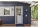 A close-up of the exterior door of a blue lake house with white trim at 6497 Osprey Dr, Nineveh, IN 46164