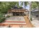 Lake house exterior showcasing a multilevel wooden deck and lakeside access at 6497 Osprey Dr, Nineveh, IN 46164