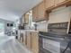Bright kitchen with wood cabinets, grey floors, and black appliances at 6497 Osprey Dr, Nineveh, IN 46164