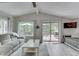 Bright living room with vaulted ceiling, patio access, and modern decor at 6497 Osprey Dr, Nineveh, IN 46164