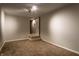 Unfinished basement with neutral carpet featuring a door and stairs leading to the next level at 6556 Reserve Dr, Indianapolis, IN 46220