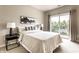 Sun-lit bedroom features a balcony, neutral colors and refined decor at 6556 Reserve Dr, Indianapolis, IN 46220
