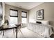 Cozy bedroom featuring a desk, neutral walls, patterned bedding and bright, natural light at 6556 Reserve Dr, Indianapolis, IN 46220
