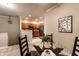 The dining room has modern decor adjacent to the kitchen with stainless steel appliances and wood cabinetry at 6556 Reserve Dr, Indianapolis, IN 46220