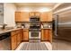 The kitchen has stainless steel appliances, wooden cabinetry, and an attractive rug at 6556 Reserve Dr, Indianapolis, IN 46220