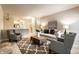 Open-concept living room features a cozy seating area and a glimpse into the kitchen, creating a welcoming atmosphere at 6556 Reserve Dr, Indianapolis, IN 46220