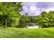 Serene view of a pond surrounded by lush greenery and trees, offering a peaceful escape at 6556 Reserve Dr, Indianapolis, IN 46220