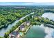 Beautiful aerial shot featuring condos between a scenic lake and winding river, surrounded by trees at 6640 Page Blvd # 101, Indianapolis, IN 46220