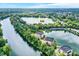 Aerial view of the community featuring scenic lake and mature trees at 6640 Page Blvd # 101, Indianapolis, IN 46220