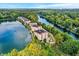 Stunning aerial view of lakeside condo complex surrounded by lush greenery and a serene lake at 6640 Page Blvd # 101, Indianapolis, IN 46220