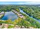 Picturesque aerial view of lakeside condos nestled among mature trees and tranquil waters at 6640 Page Blvd # 101, Indianapolis, IN 46220