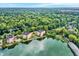 Aerial view of condos near the lake with lush green surroundings and clear skies at 6640 Page Blvd # 101, Indianapolis, IN 46220