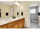 Bathroom with double sink vanity, large mirror and separate glass enclosed shower at 6640 Page Blvd # 101, Indianapolis, IN 46220