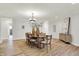 Cozy dining room area featuring a chandelier, wood floors, and modern décor at 6640 Page Blvd # 101, Indianapolis, IN 46220