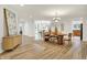 Open dining room area featuring modern decor, wood floors, and natural light at 6640 Page Blvd # 101, Indianapolis, IN 46220