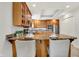 Well-lit kitchen featuring wood cabinets, stainless appliances, and granite countertops at 6640 Page Blvd # 101, Indianapolis, IN 46220