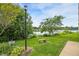 Peaceful lawn area with a bench offering a scenic view of the lake and lush greenery at 6640 Page Blvd # 101, Indianapolis, IN 46220
