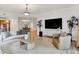 Spacious living area showcasing a modern entertainment center and a seamless transition to the dining room at 6640 Page Blvd # 101, Indianapolis, IN 46220